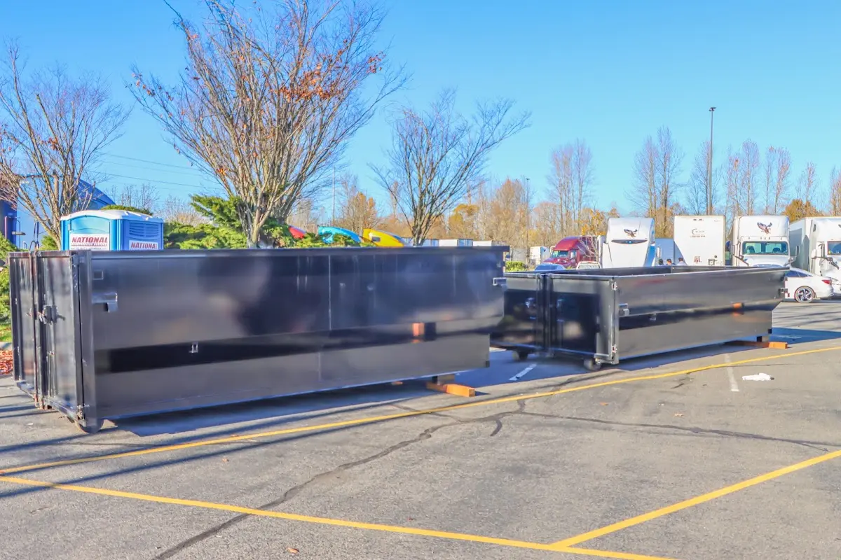 Professional dumpster rental service with roll-off container on residential driveway in Isla Vista